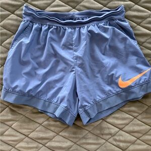 Nike Women's Light Blue Athletic Shorts with Orange Swoosh